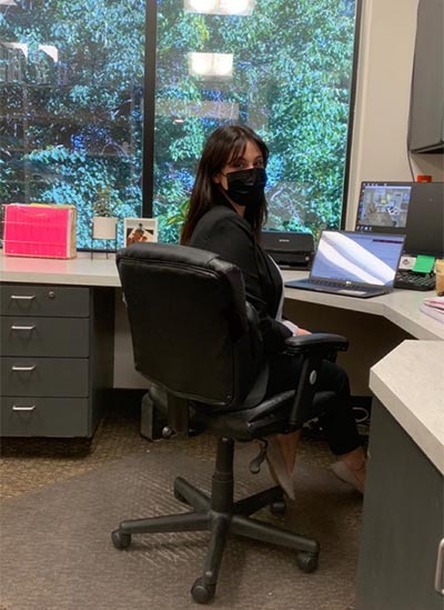 treatment coordinator sitting at her desk at Cascade Dental Care