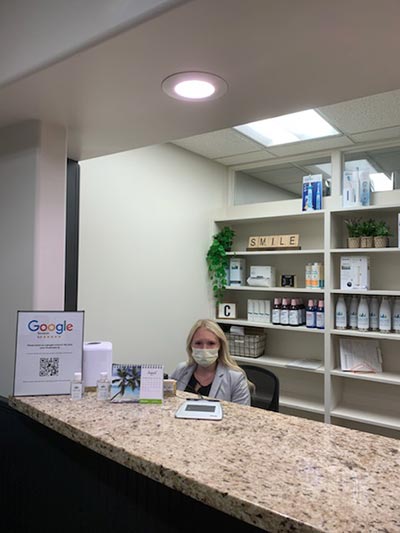 office coordinator sitting at the front desk of Cascade Dental Care